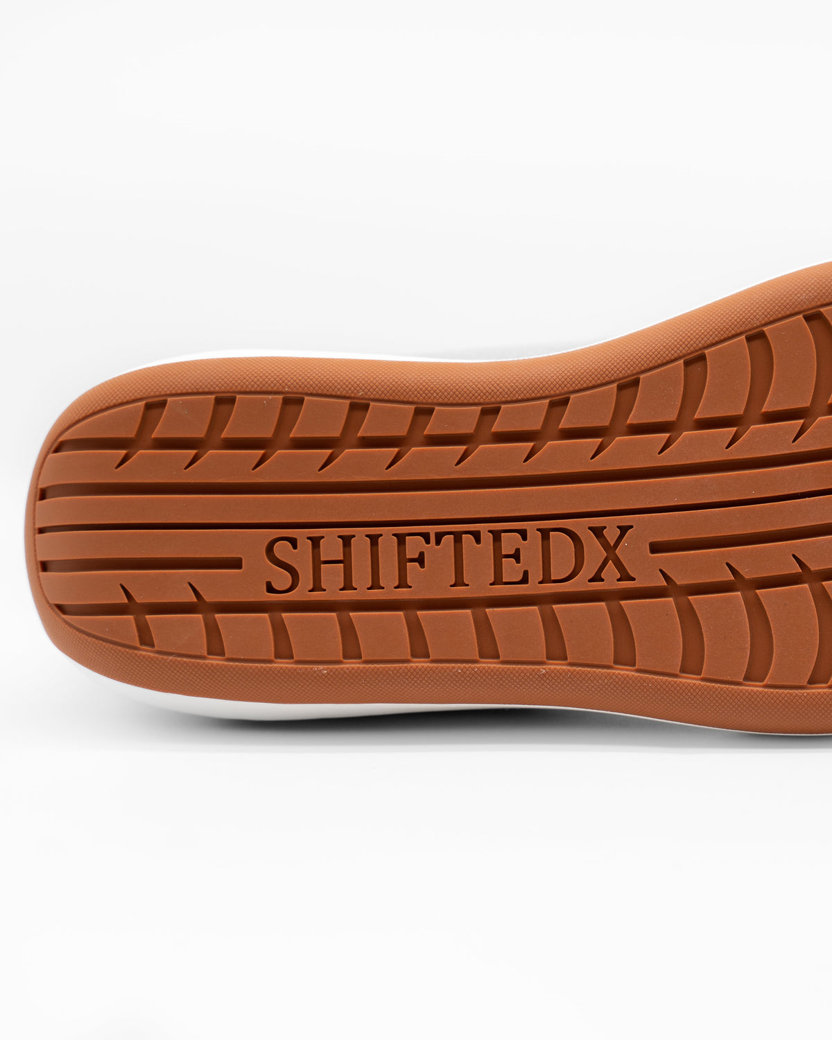 Brown shoe sole with 'SHIFTEDX' branding on a white background